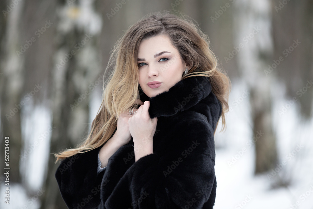 Fashionable winter portrait of lady with long hair in city Fashionable winter portrait of lady with long hair in city