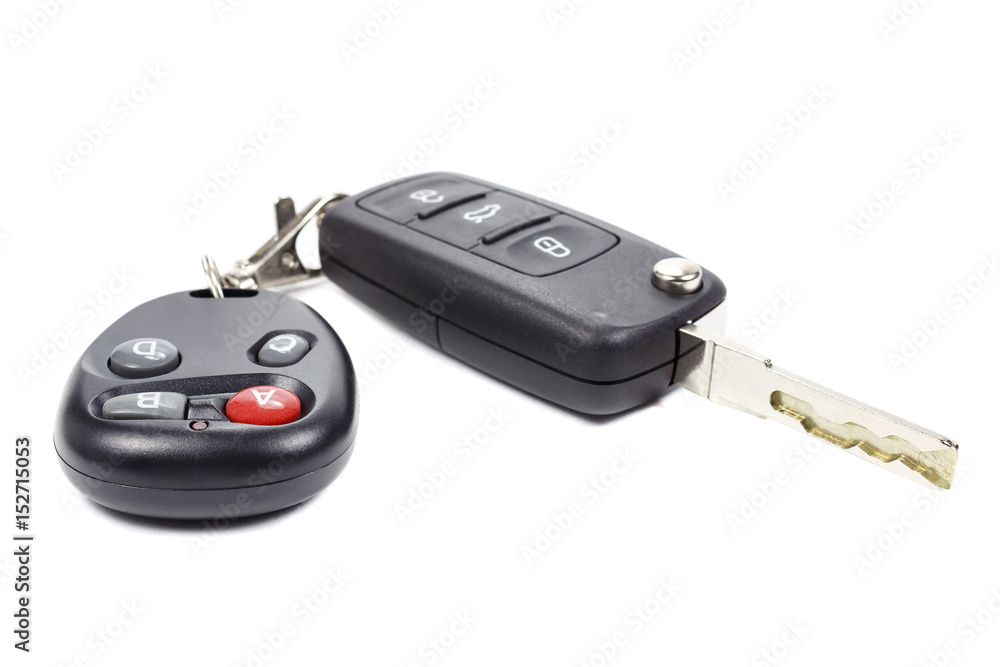 Ignition key and garage door remote control on a white background Ignition key and garage door remote control on a white background