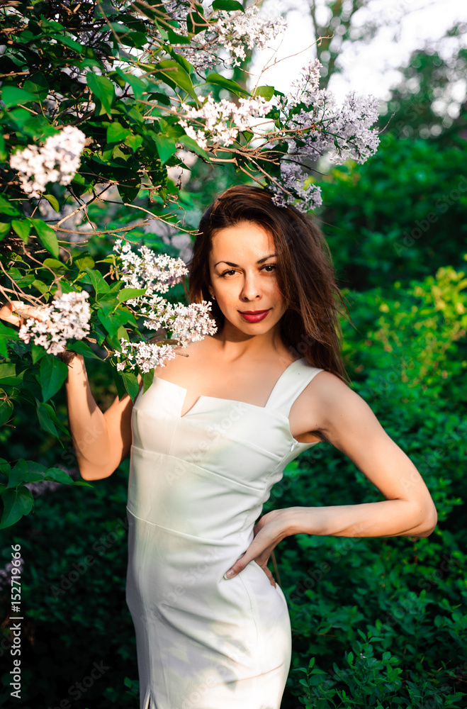 Young girl in complete tranquility and pacification in a beautiful and elegant dress on nature in the spring in the park Young girl in complete tranquility and pacification in a beautiful and elegant dress on nature in the spring in the park