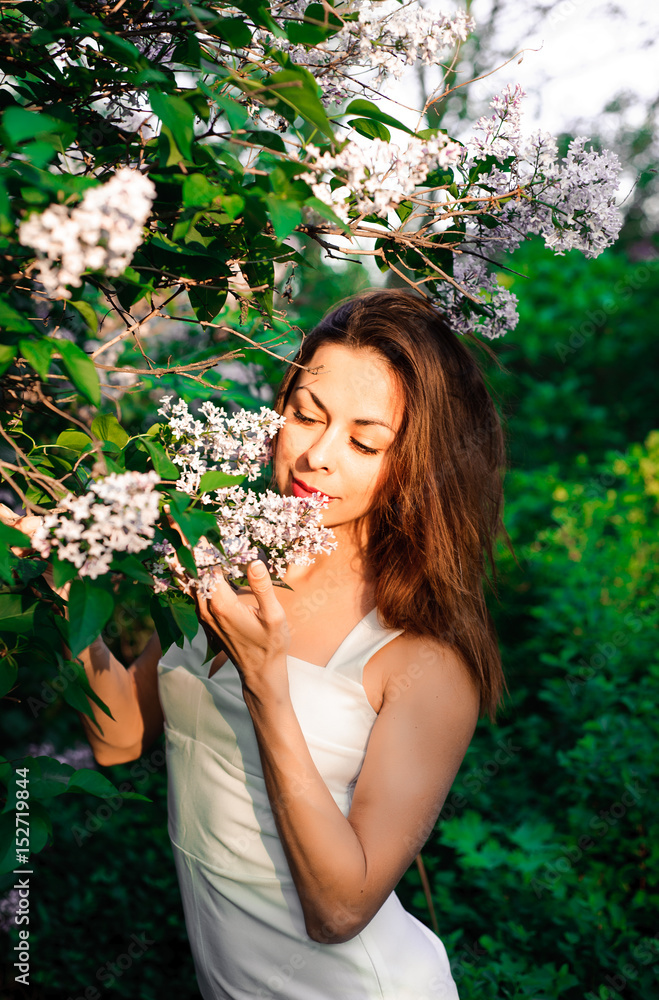 Young girl in complete tranquility and pacification in a beautiful and elegant dress on nature in the spring in the park Young girl in complete tranquility and pacification in a beautiful and elegant dress on nature in the spring in the park