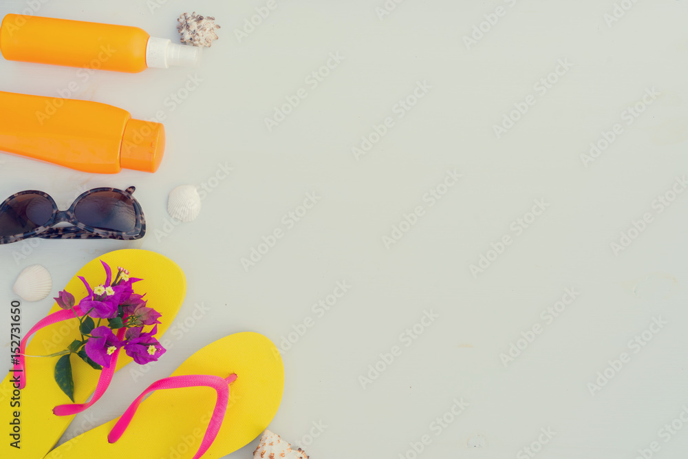 Summer beach fun - border of sandals with glasses and sunscreens, retro toned Summer beach fun - border of sandals with glasses and sunscreens, retro toned