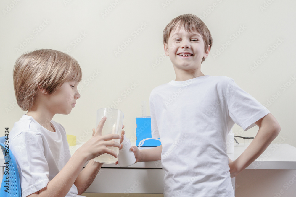 Kids have fun while doing science experiments. Education concept. Kids have fun while doing science experiments. Education concept.
