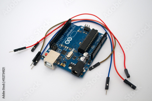 Arduino and around listed wire on a white background