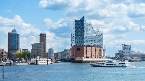 Hamburg, elbphilharmonie and modern buildings with boat to the harbor tour photo