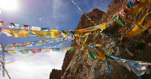 4k Prayer flags at the lake namtso in tibet,ancient holy monk meditation in cave,ZhaXi Peninsula,tibet mansarovar,Tibet's second largest lake,is the third largest saltwater lake in China. photo