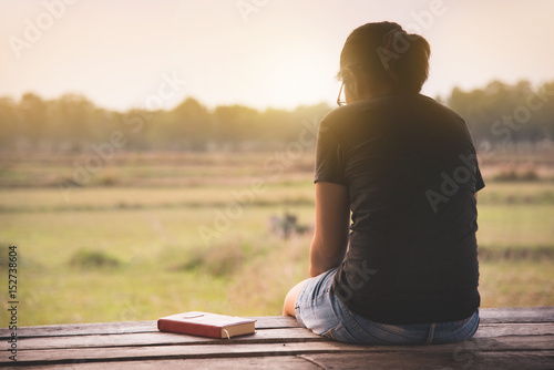 Asian woman sitting on countryside background in the morning.