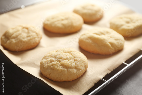 Fotografía Tasty sugar cookies on parchment paper, closeup