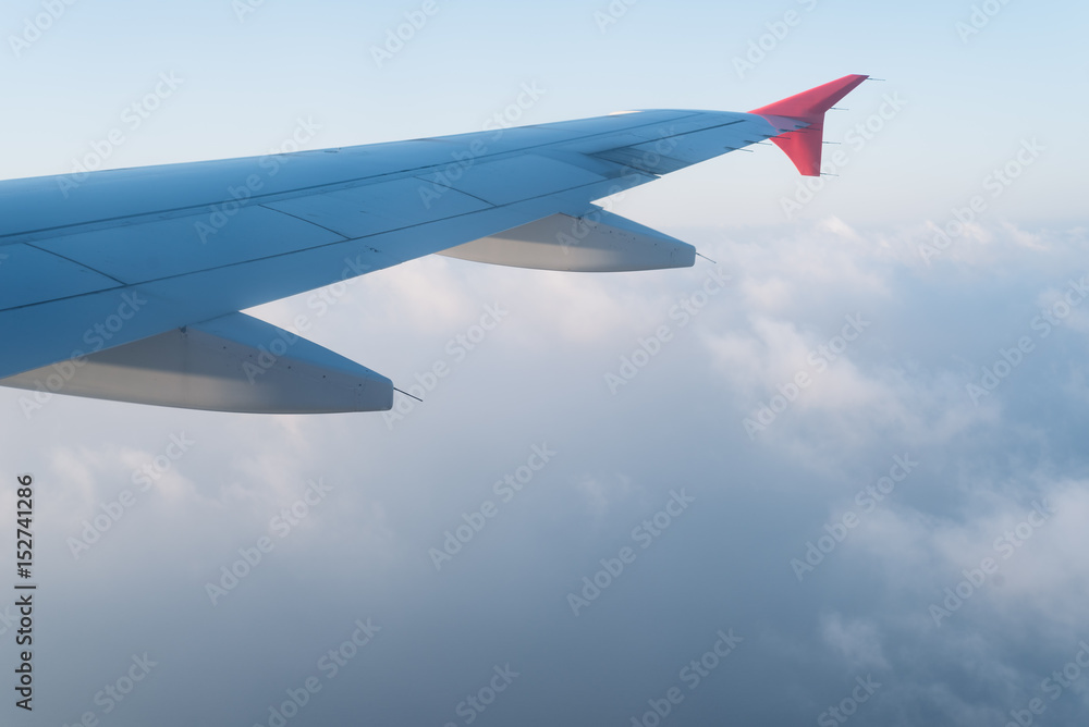 Fototapeta premium Clouds under the wing of an airplane