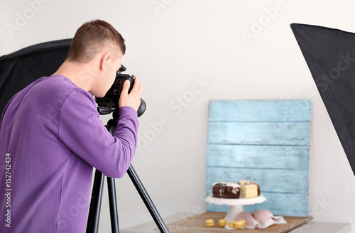 Young man photographing foo...