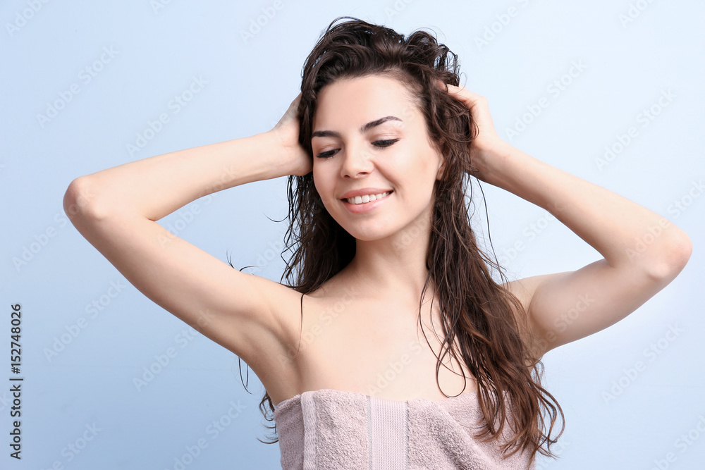 Fototapeta premium Beautiful young woman after shower on color background