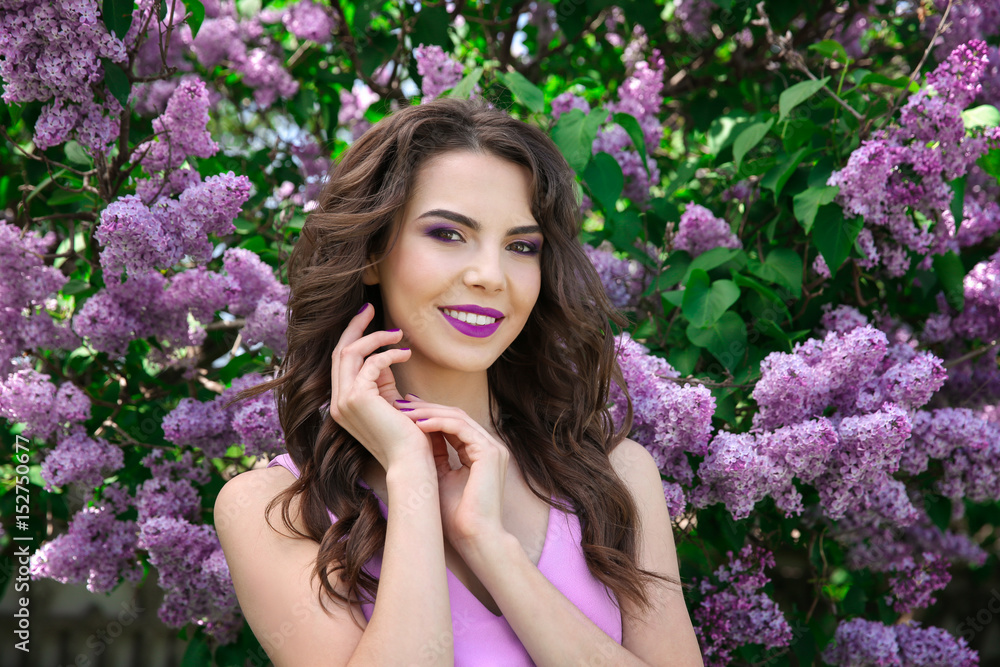 Beautiful young woman with lilac make up in spring garden Beautiful young woman with lilac make up in spring garden