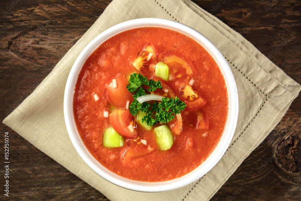 A bowl of gazpacho soup on rustic texture A bowl of gazpacho soup on rustic texture