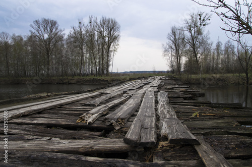 Old wooden bridge over the river in spring