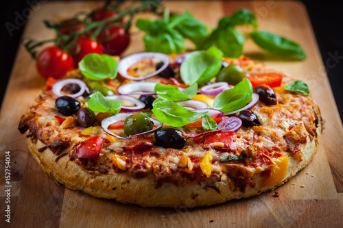 Traditional homemade pizza with tomatoes and olives