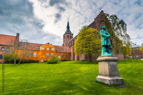 Fényképezés Odense, Denmark - April 29, 2017: Cathedral of Saint Canute and Statue of Hans C