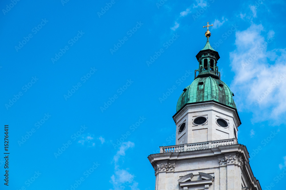 white tower,green roof,gold cross on top