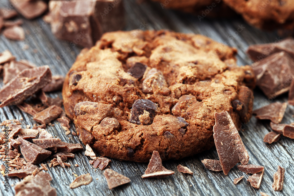 Fototapeta premium Chocolate cookies on wooden table. Chocolate chip cookies shot