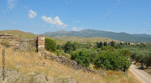 Hill and countryside close to Molyvos, Lesvos with stone wall gate and Olive trees