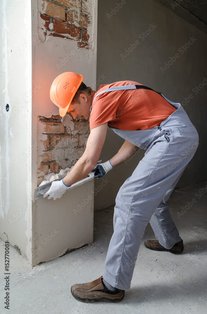 Worker is putting a gypsum plaste. Worker is putting a gypsum plaste.