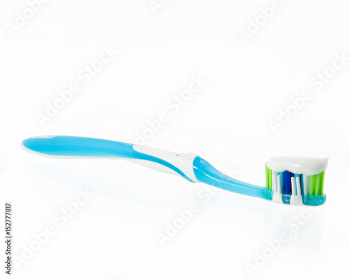 toothpaste at a toothbrush at white background