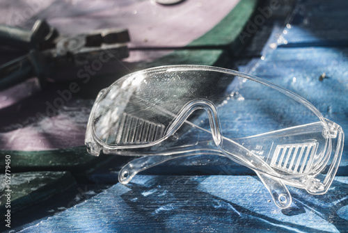 protective transparent plastic glasses on a wooden backgroun