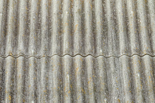 Asbestos cement sheets. Texture of old laid roofing sheets. Grey roof tiles.
