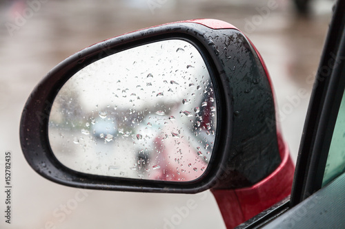 raindrops on side rear view mirror in rain