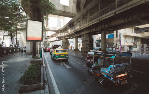 Traffic moves slowly along a busy highway road with subway MRT line above the road near the city center in Bangkok, Thailand. Cityscape photography of the capital city of Thailand - Bangkok, Asia