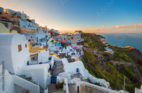 Oia town on Santorini island, Greece. Traditional and famous houses and churches with blue domes over the Caldera, Aegean sea