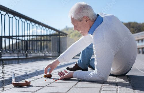 Pleasant pensioner having health problem outdoors