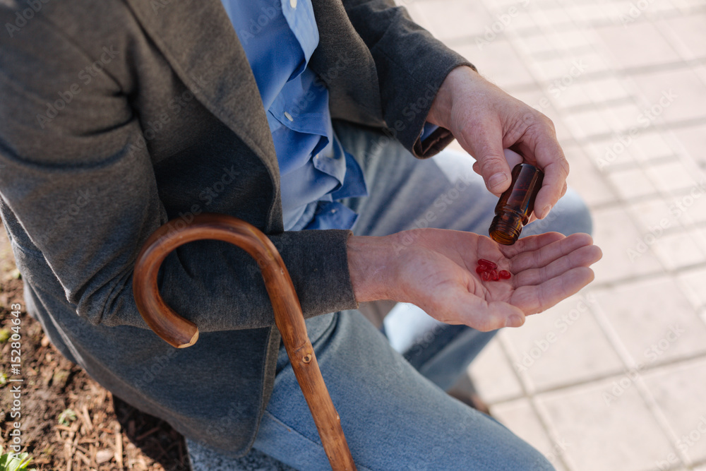 Fototapeta premium Pleasant man solving his health problem in the street