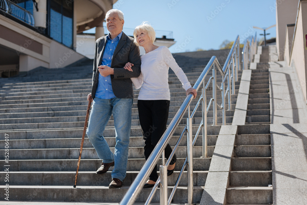 Aged couple enjoying walk in the square Aged couple enjoying walk in the square