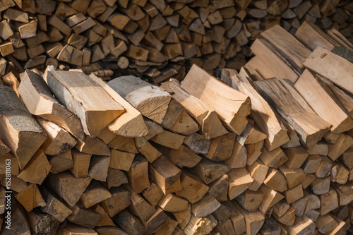 Hand chopped wooden logs put in particular order on a pile