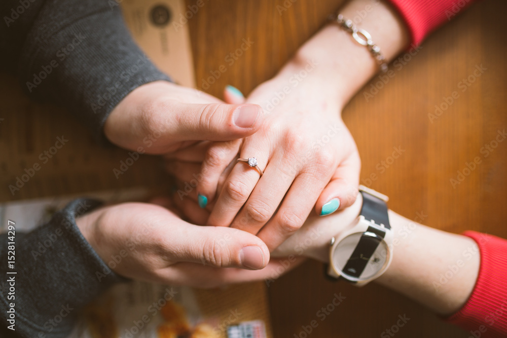 two pairs of hands in love tenderly hold together