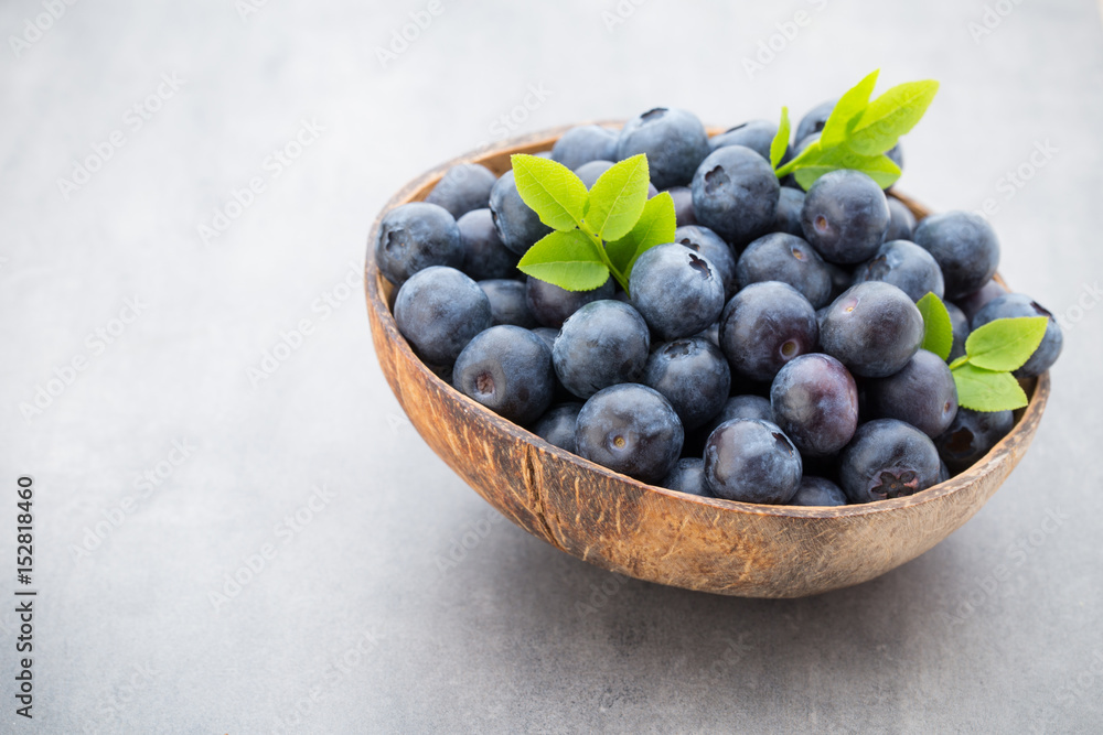 Fresh blueberries natural coconut in a bowl on a gray background. Fresh blueberries natural coconut in a bowl on a gray background.