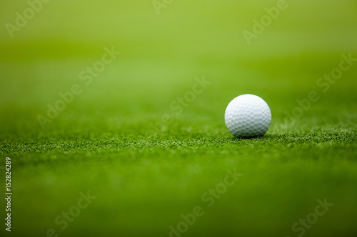 Golf ball on tee in the grass.