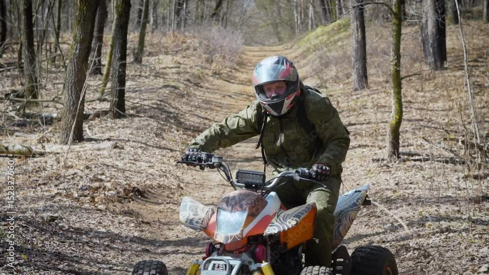 Extreme vacation in the woods on the ATV. Men engage in motor sport, quad bike is an ideal means for riding on country roads. All wheel drive helps to overcome obstacles, and to conquer the terrain Extreme vacation in the woods on the ATV. Men engage in motor sport, quad bike is an ideal means for riding on country roads. All wheel drive helps to overcome obstacles, and to conquer the terrain