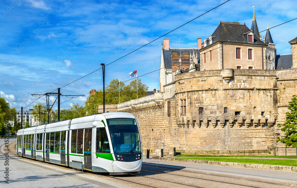 City tram at the Castle of the Dukes of Brittany in Nantes, France - obrazy, fototapety, plakaty 