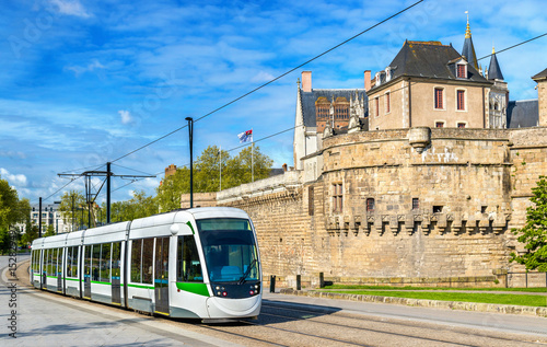 City tram at the Castle of the Dukes of Brittany in Nantes, France