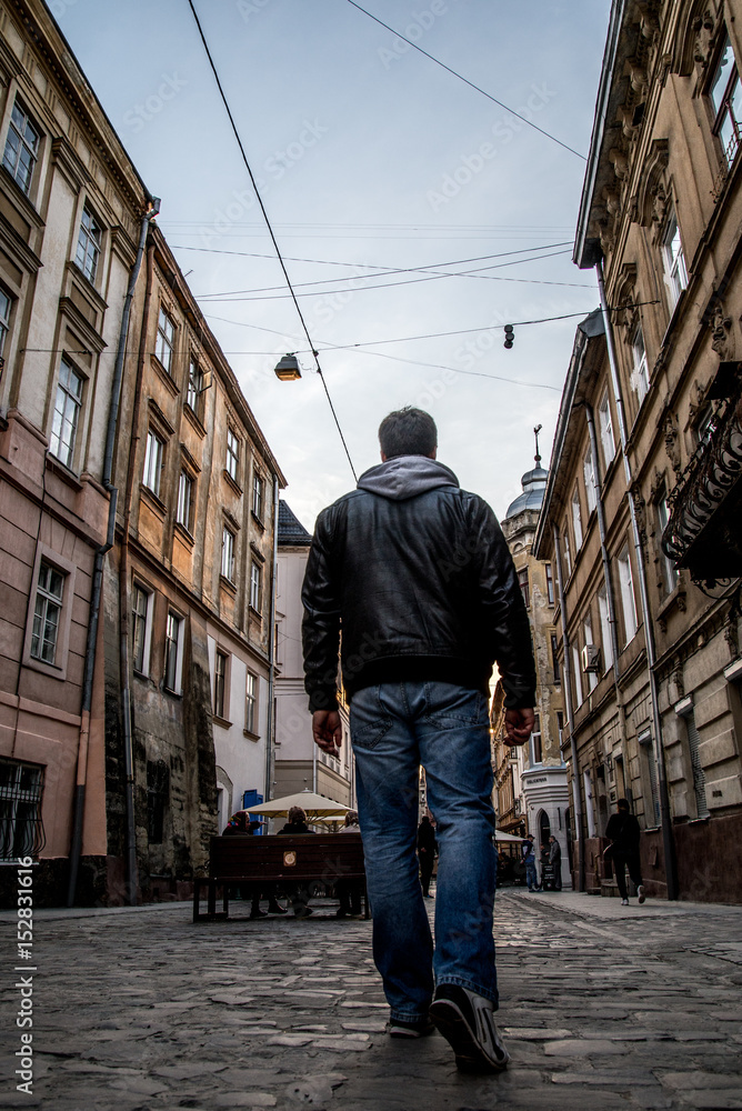 man walking by old europian city