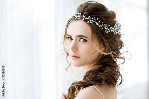 Closeup brunette bride with fashion wedding hairstyle and makeup
