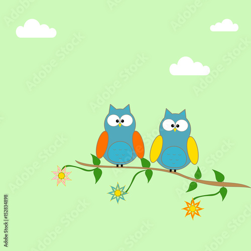 Owls on a branch of a tree