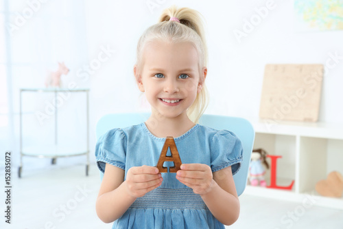 Cute little girl with lette...