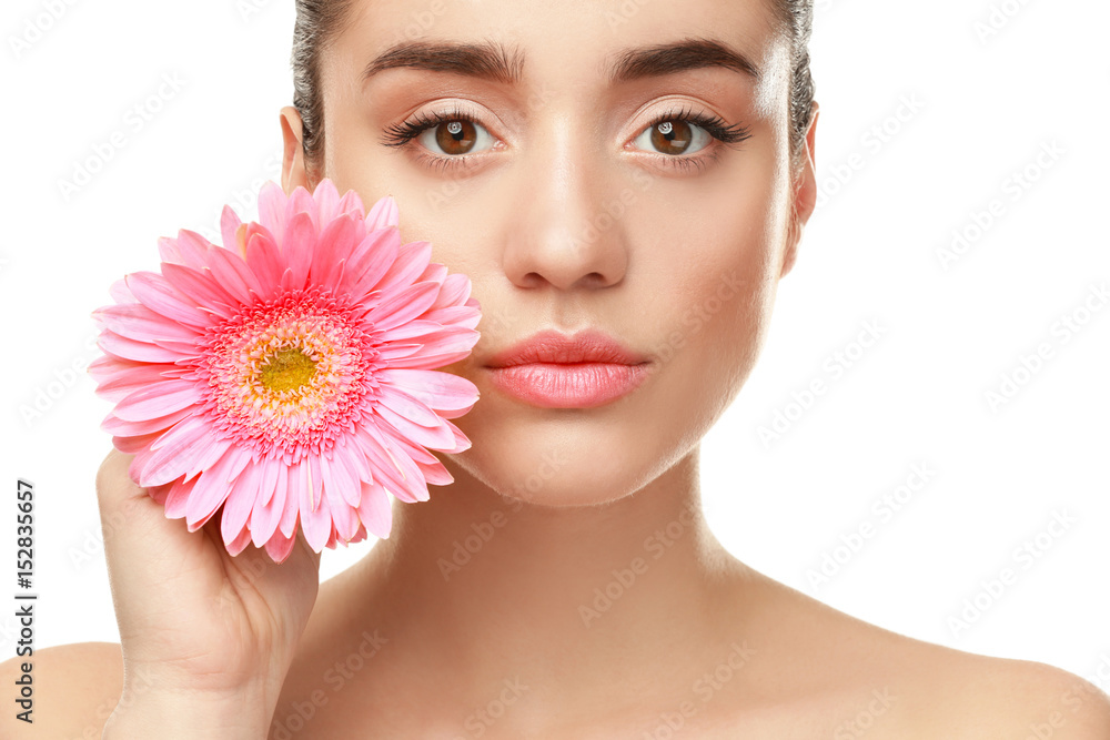 Beautiful young woman with flower on white background, closeup