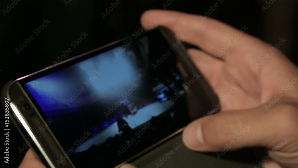 Male watching break-dance battle video on mobile phone, modern technologies Male watching break-dance battle video on mobile phone, modern technologies