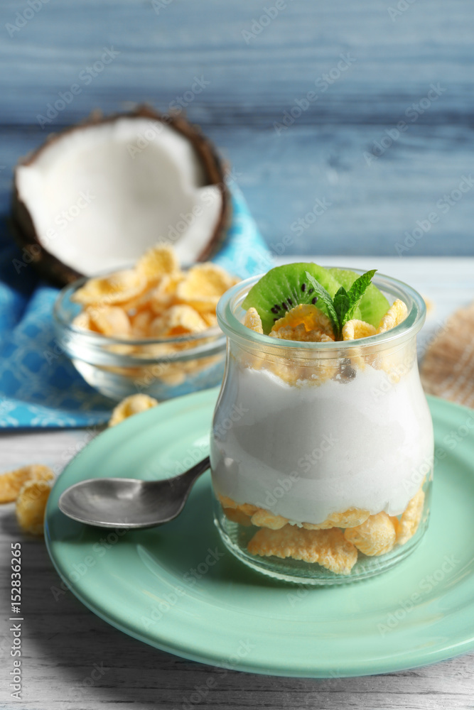 Delicious coconut cream in jar on wooden background Delicious coconut cream in jar on wooden background