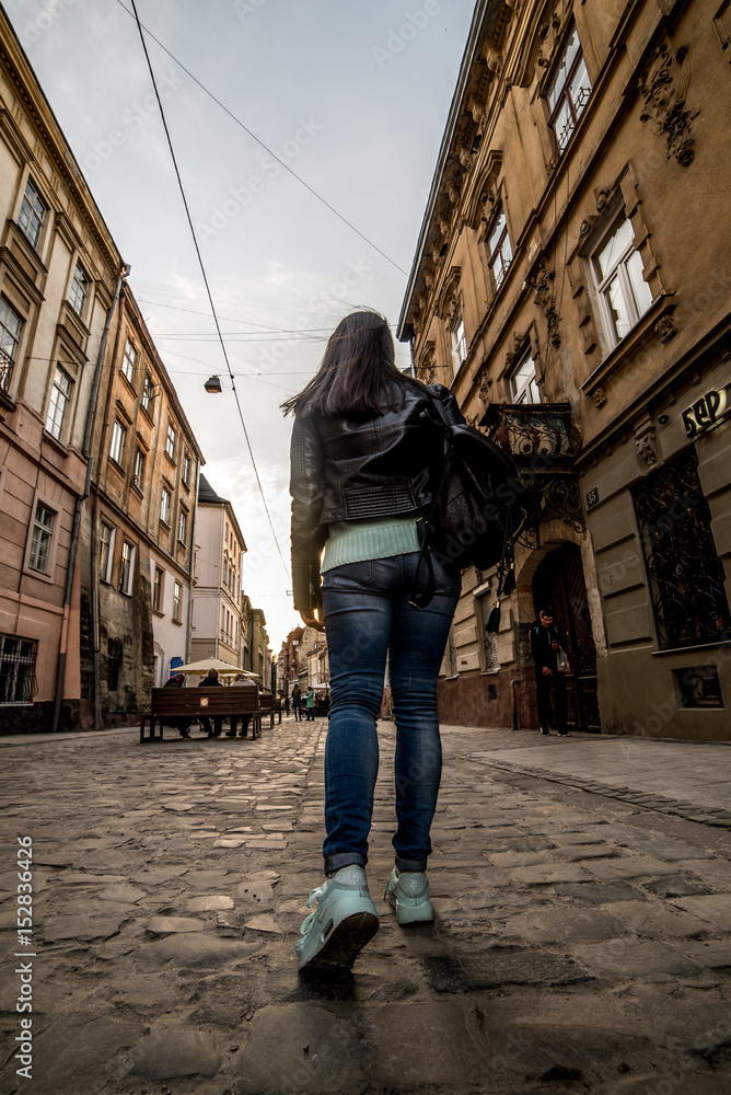 woman walking by old europian city
