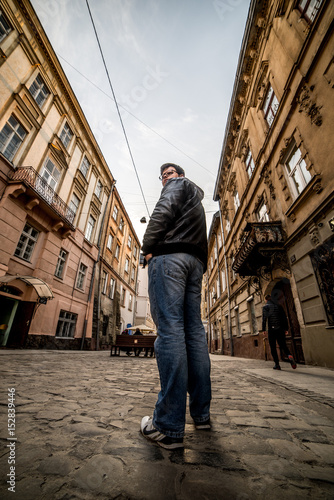 man walking by old europian city © phpetrunina14