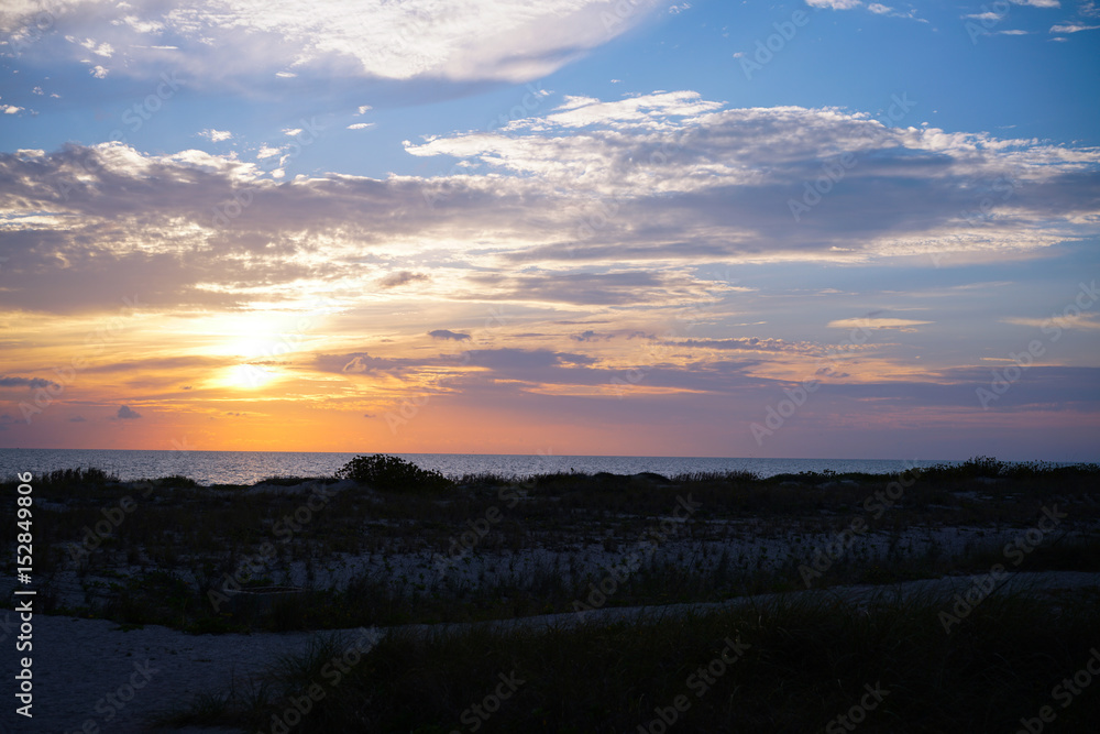A look at the sunset from the sand dunes on Venice beach in southwest Florida.