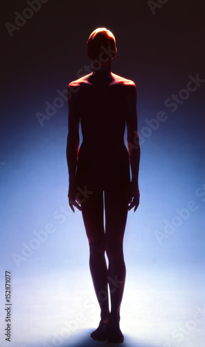 Female silhouette against a blue background.